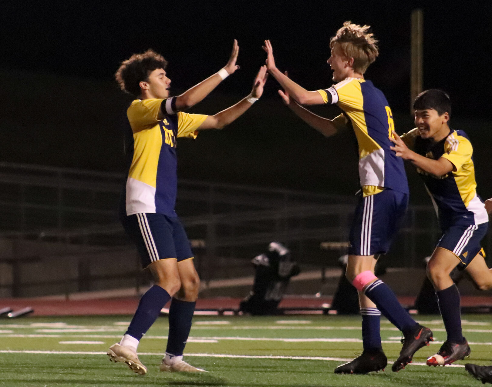 Kaden Fugate, Parker Murphy and Travis Peng celebrate after Murphy’s goal